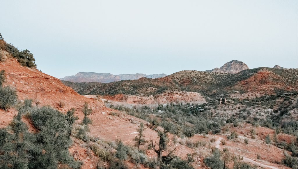 A  range of red rock mountains under a clear daytime sky in Northern Arizona.