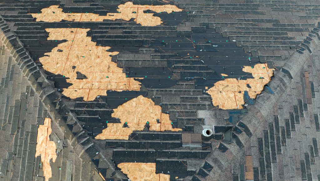 A roof with old, brittle, cracked, and missing shingles.