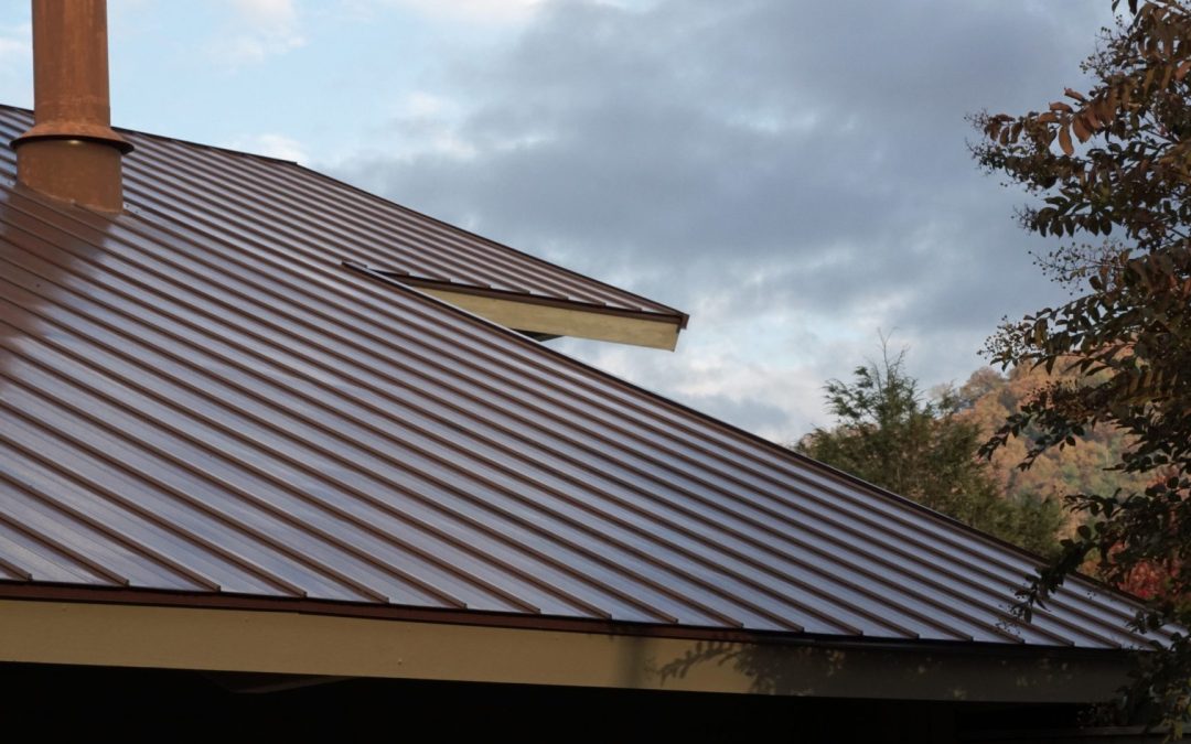 A close-up of a roof with a brown standing seam steel roof.