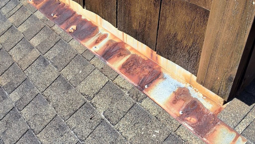 Severe flashing damage on an asphalt shingle roof.