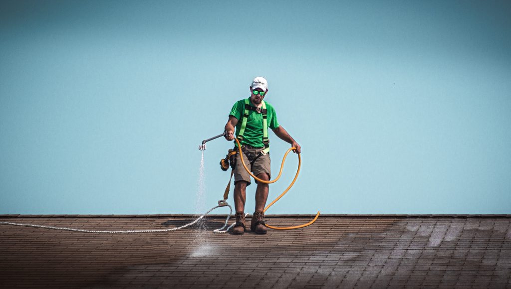 A certified Roof Maxx dealer applies the all-natural treatment to an asphalt shingle roof.