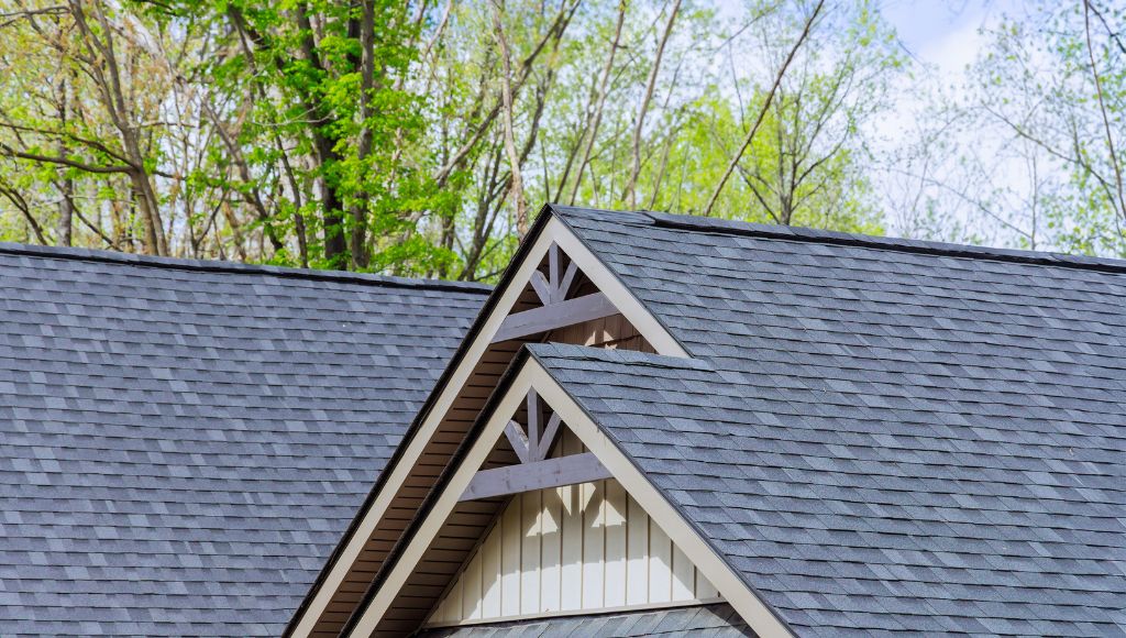 A close-up of a residential home with blue-grey asphalt shingles.