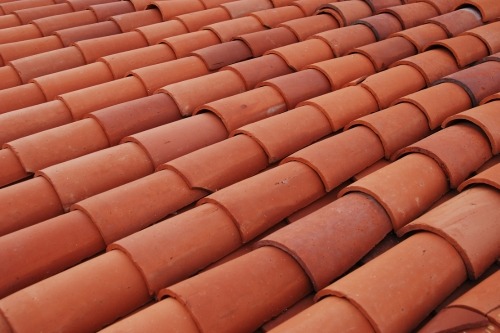 Worn curling asphalt shingles Asphalt shingles curling and lifting from age and UV damage